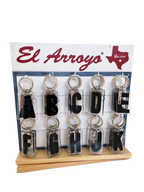 Set of keychains with letters A to L on a display stand with El Arroyo branding.